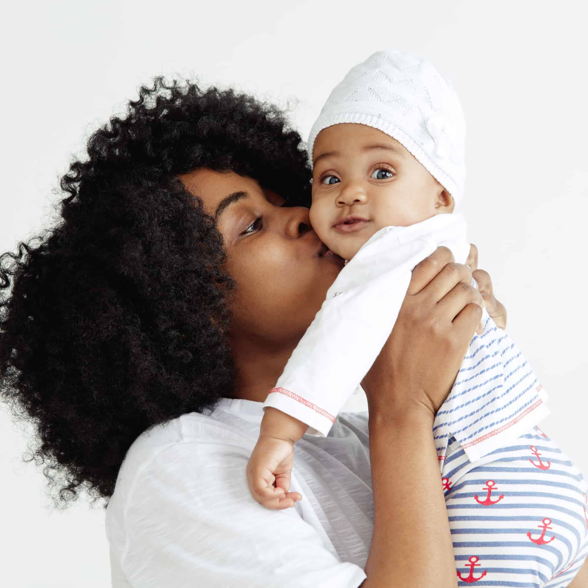 mom kissing baby square