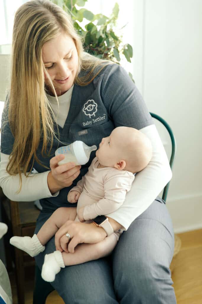 Woman feeding a baby a bottle