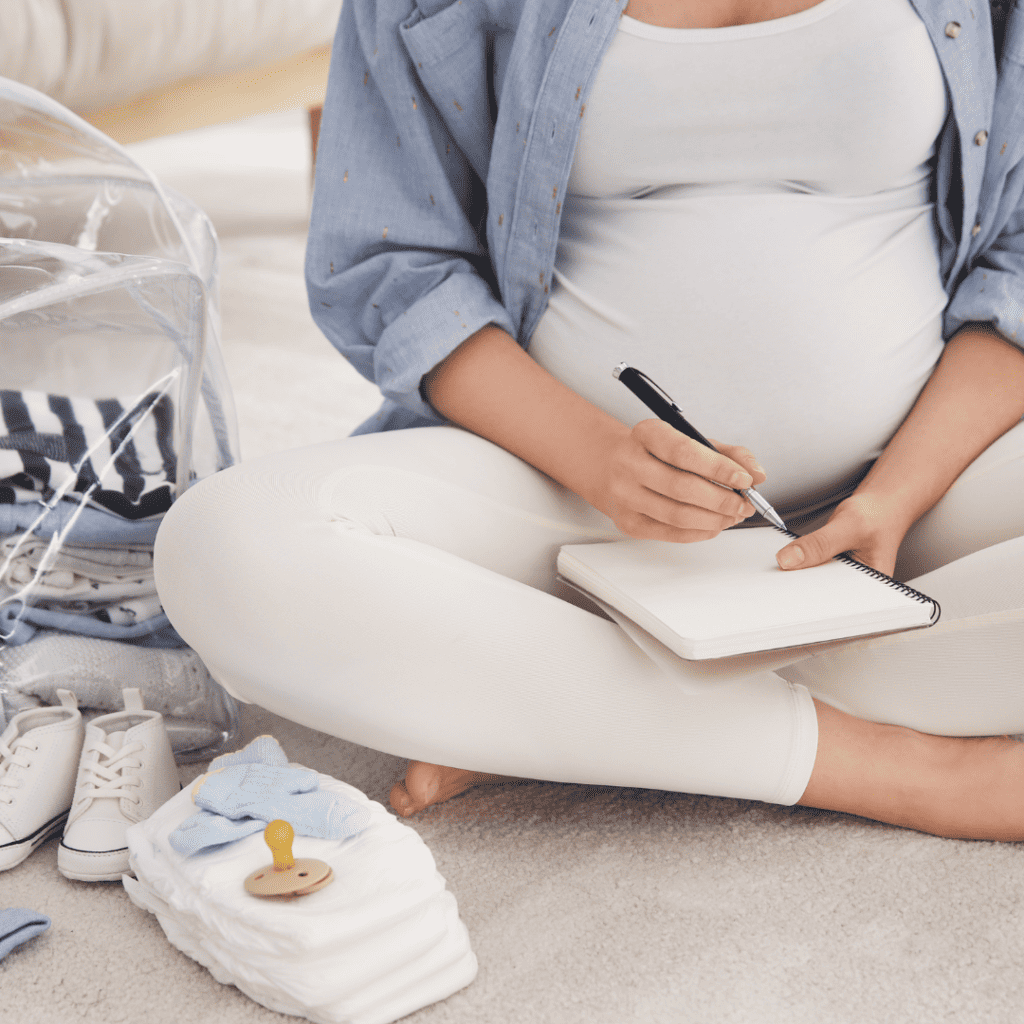 Pregnant woman writing a list. 