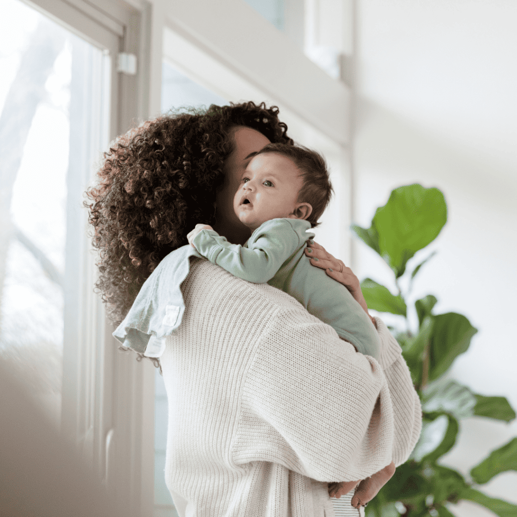 Woman burping baby