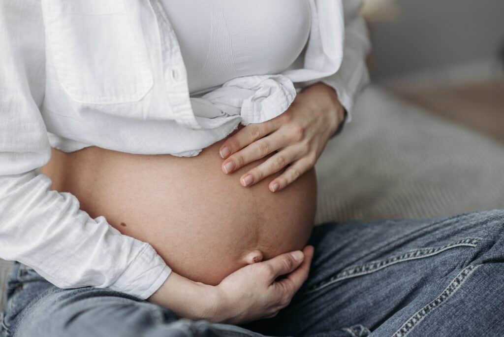 Pregnant woman holding her belly