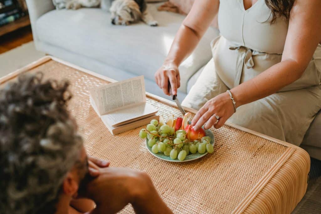 Common Pregnancy Myths Debunked Pregnant woman cutting up apple