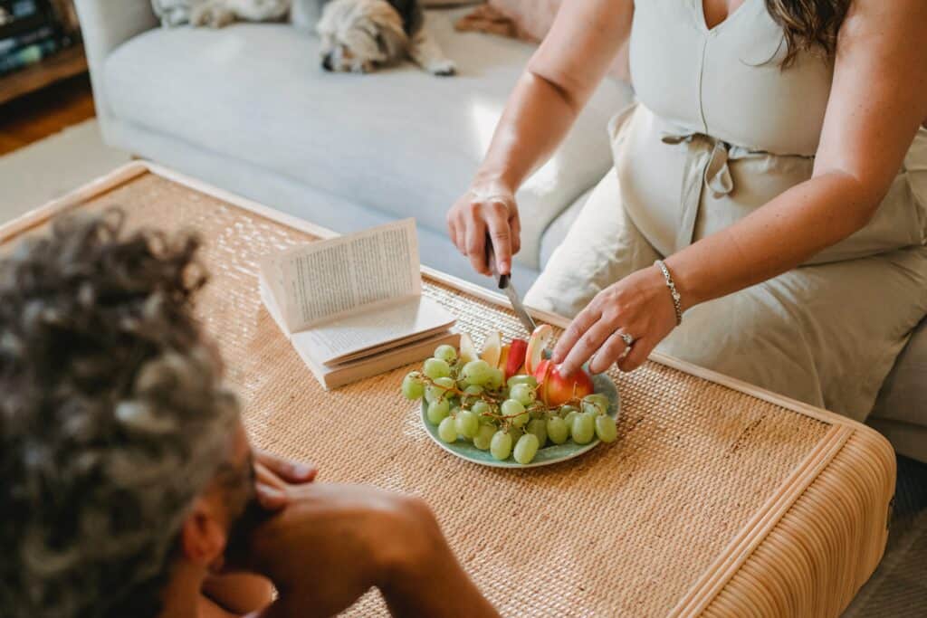 Pregnant woman cutting up apple