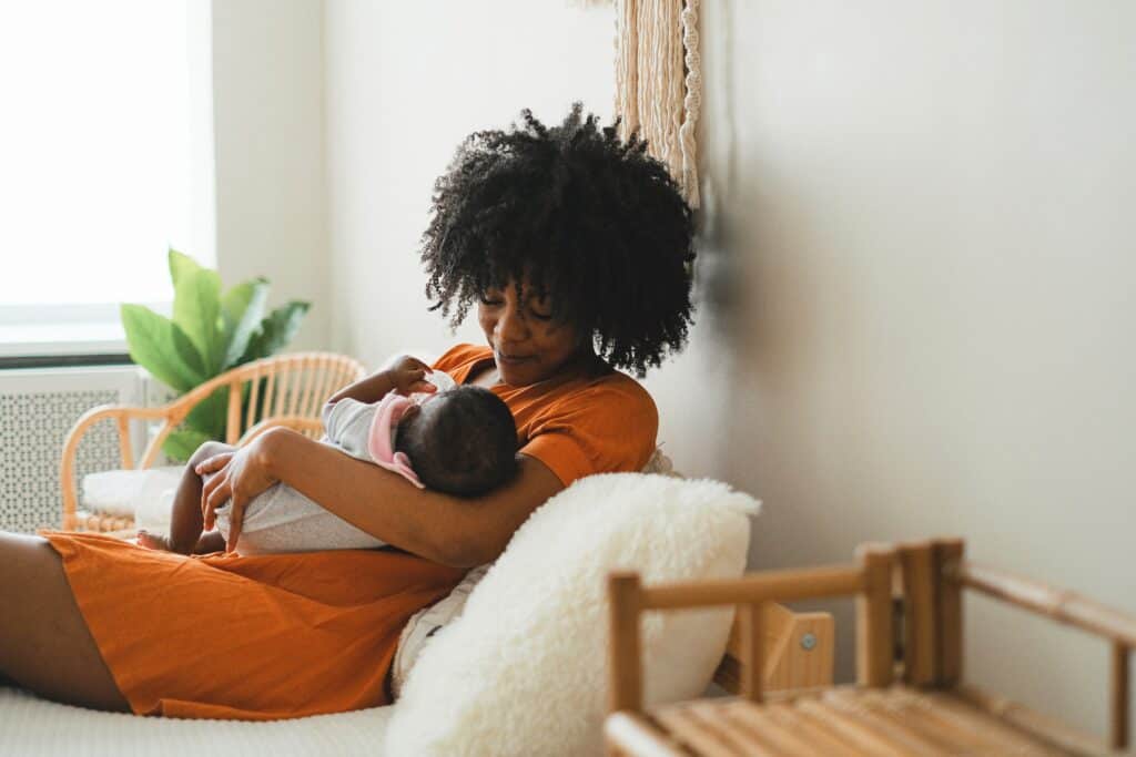 Woman bottle feeding baby