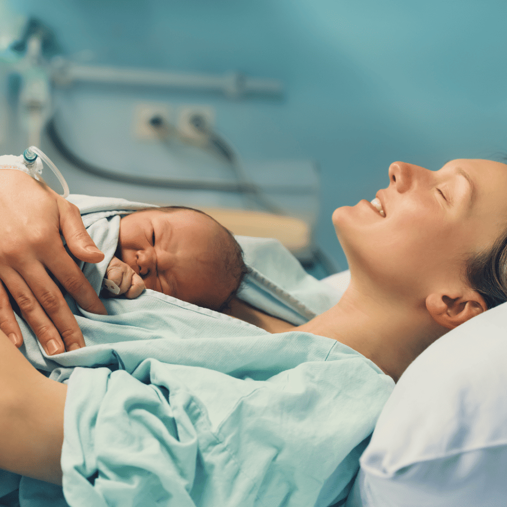 Woman laying on her back with newborn baby on her chest