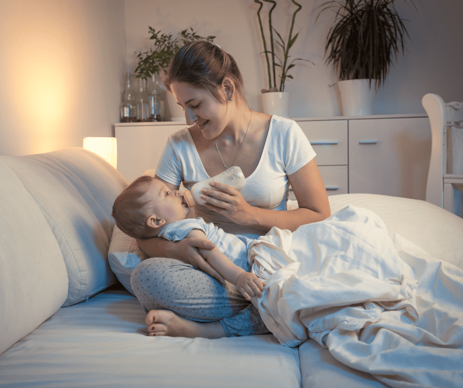 Woman bottle feeding baby