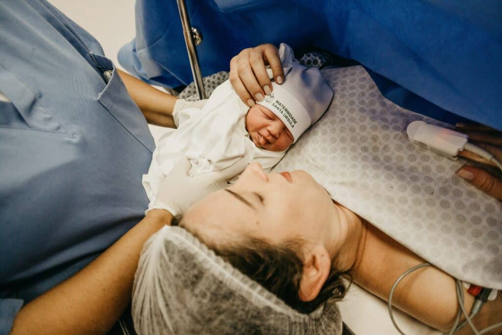Women looking after newborn baby after giving birth
