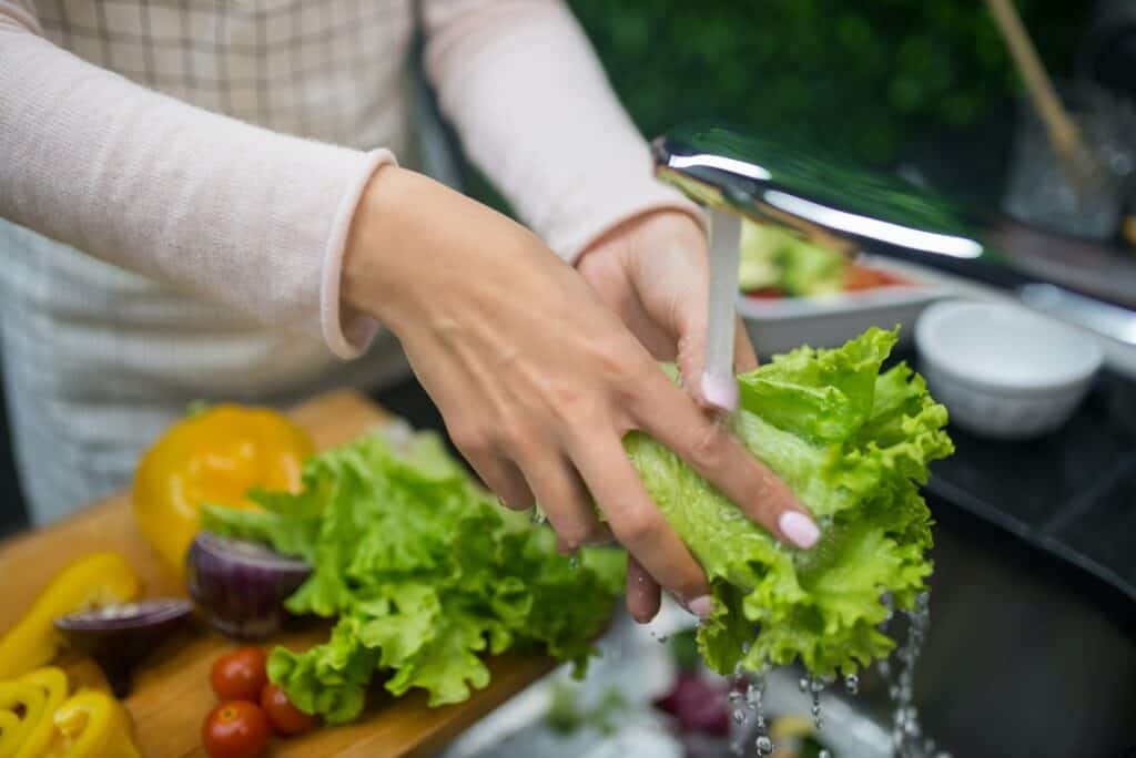 Woman washing lettuce 