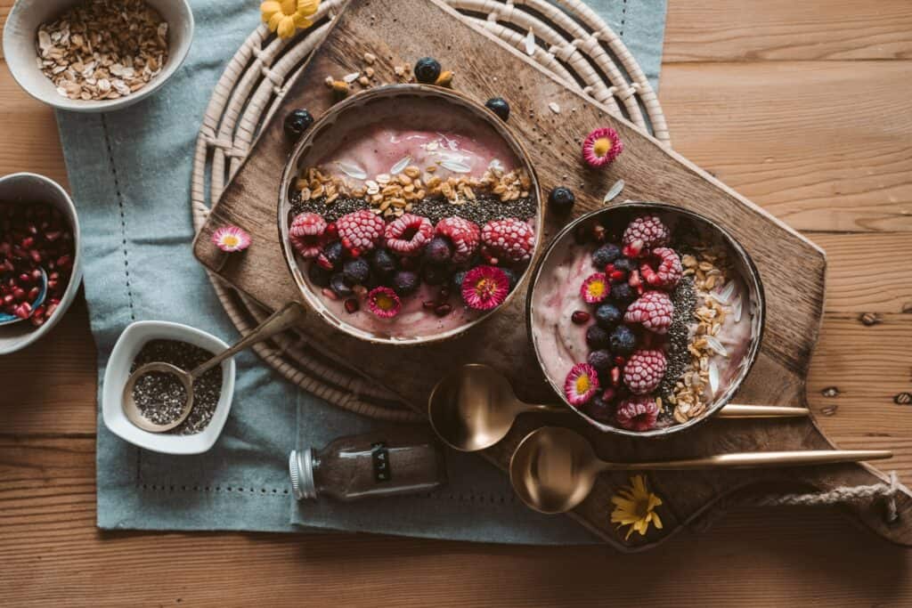 Wooden board with smoothie bowls 