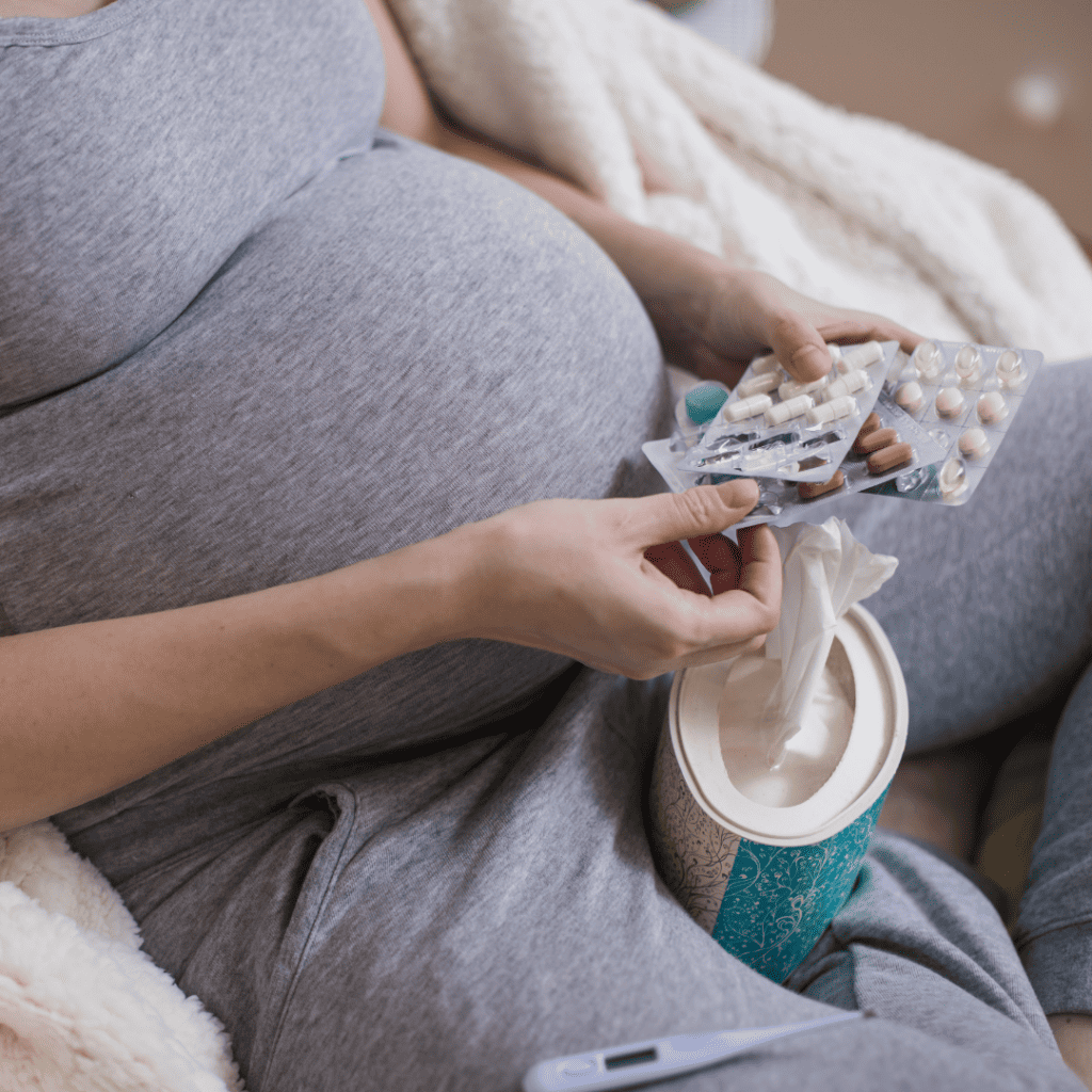 Pregnant woman with medication in her hand