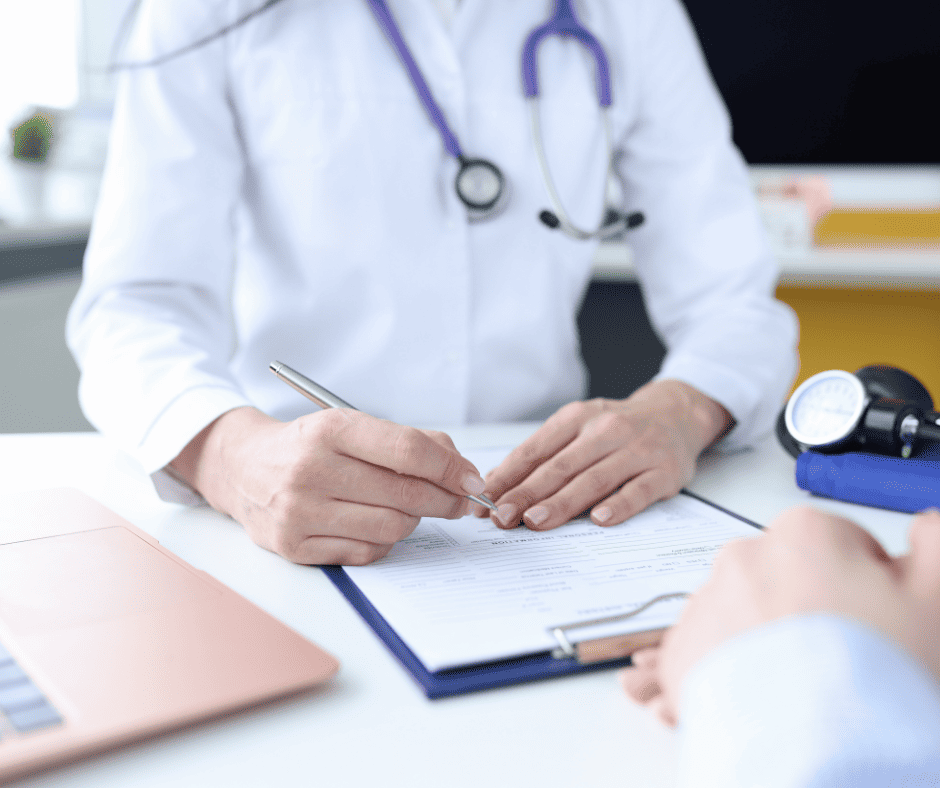 Preparing for pregnancy Doctor filling out form on clipboard