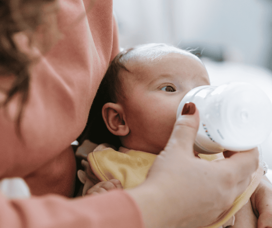 Woman bottle feeding a baby