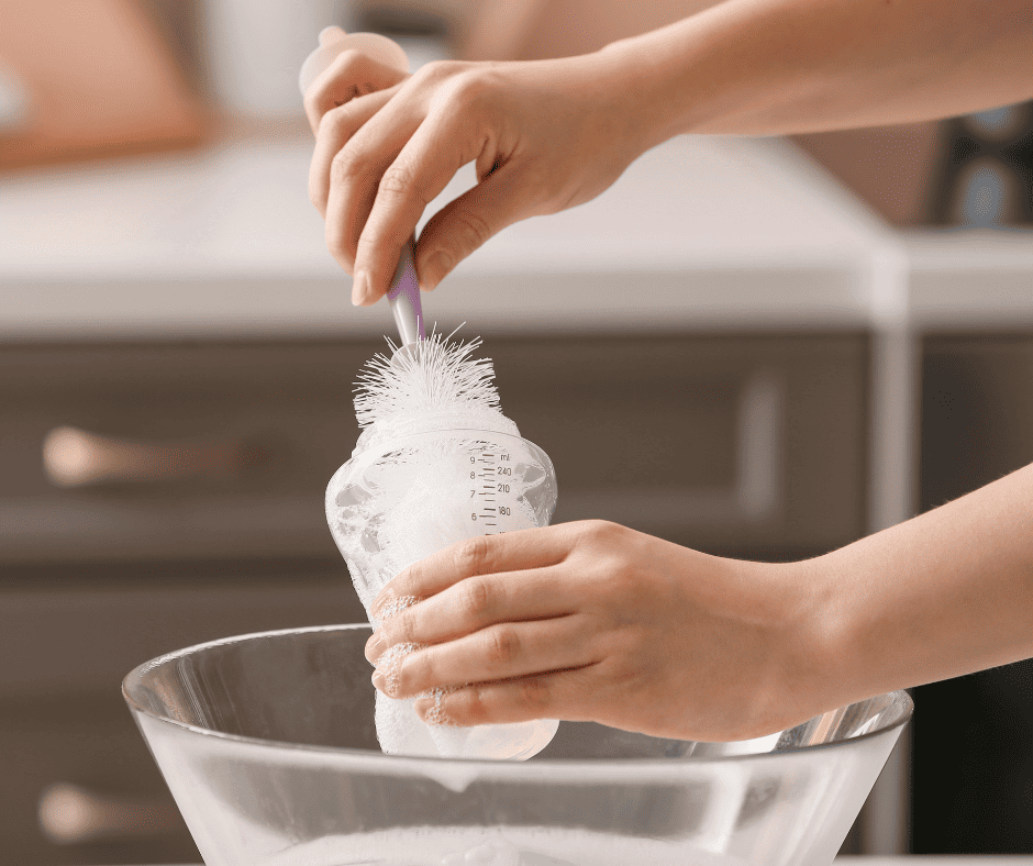 Person washing a baby bottle