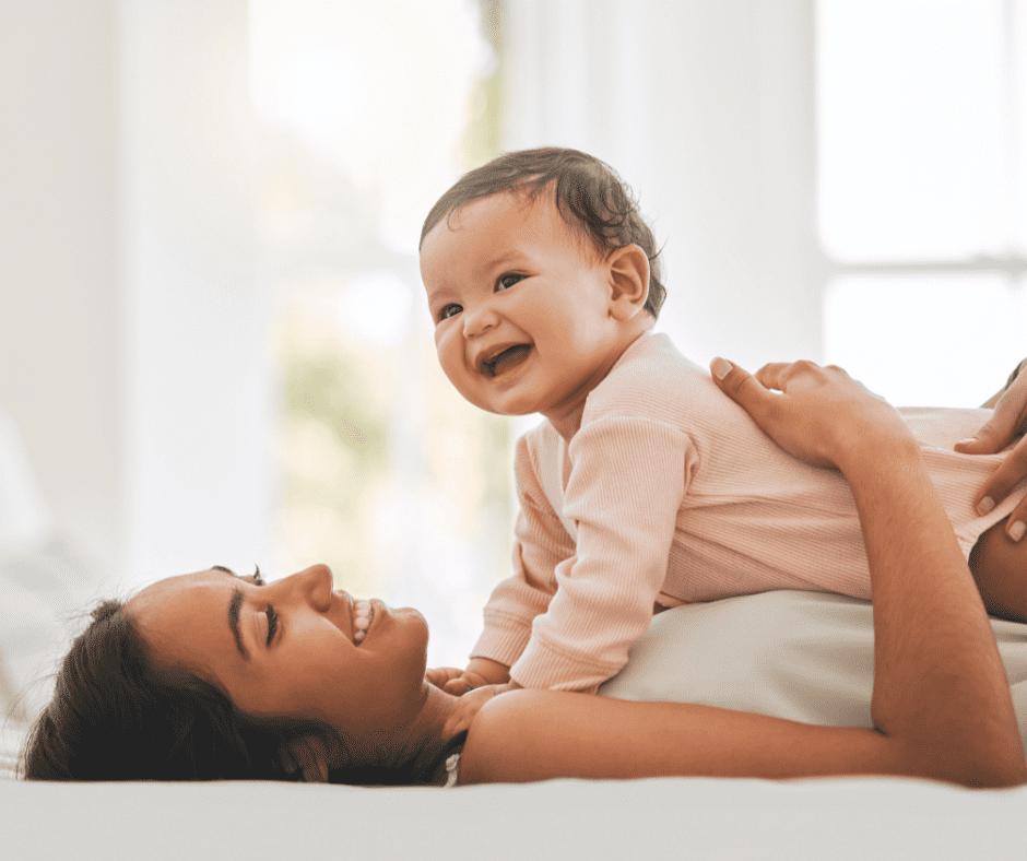 Woman laying on back with baby on her chest