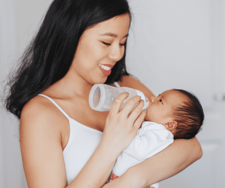 Woman bottle feeding baby