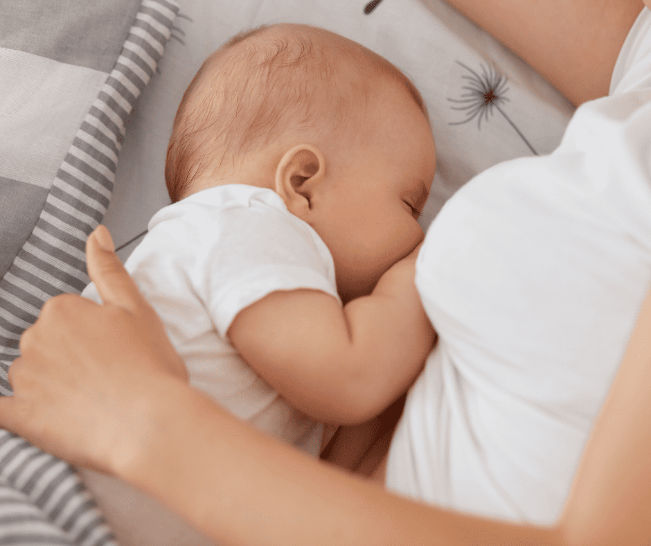 Woman laying on side breastfeeding