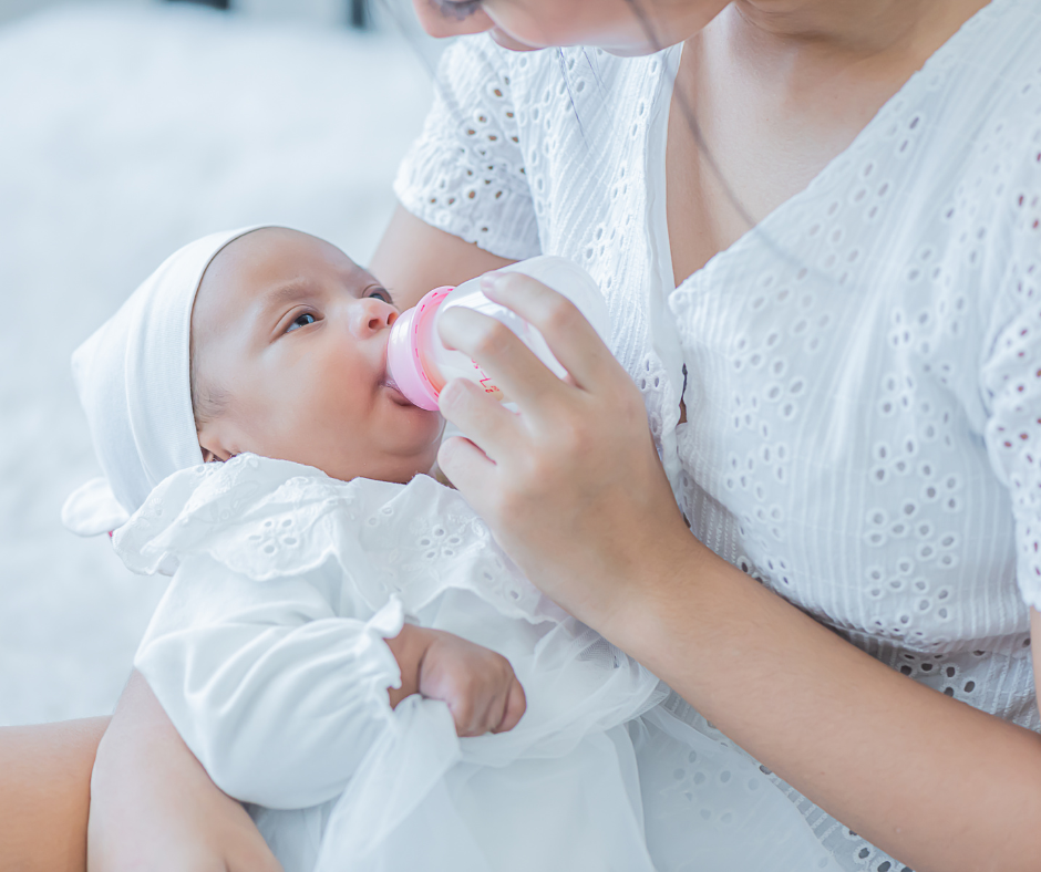 Woman feeding baby with a bottle