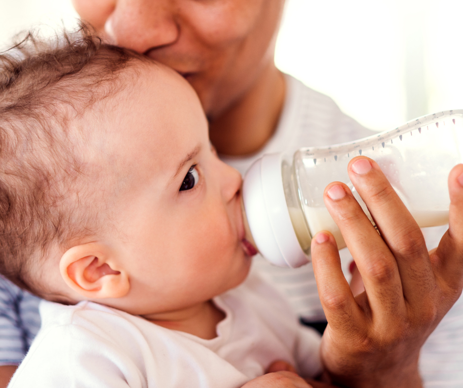 Man feeding baby a bottle