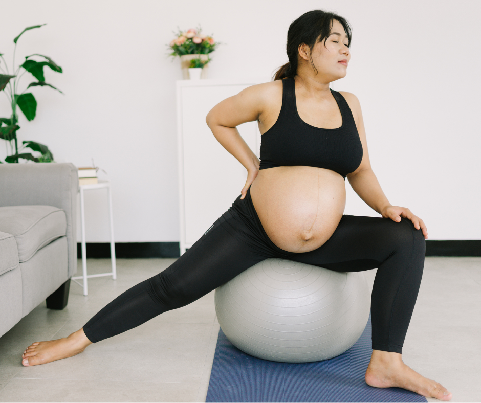 Heavily pregnant woman on exercise ball