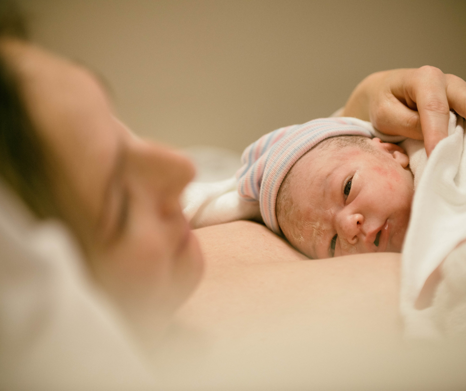 Woman holding baby after giving birth