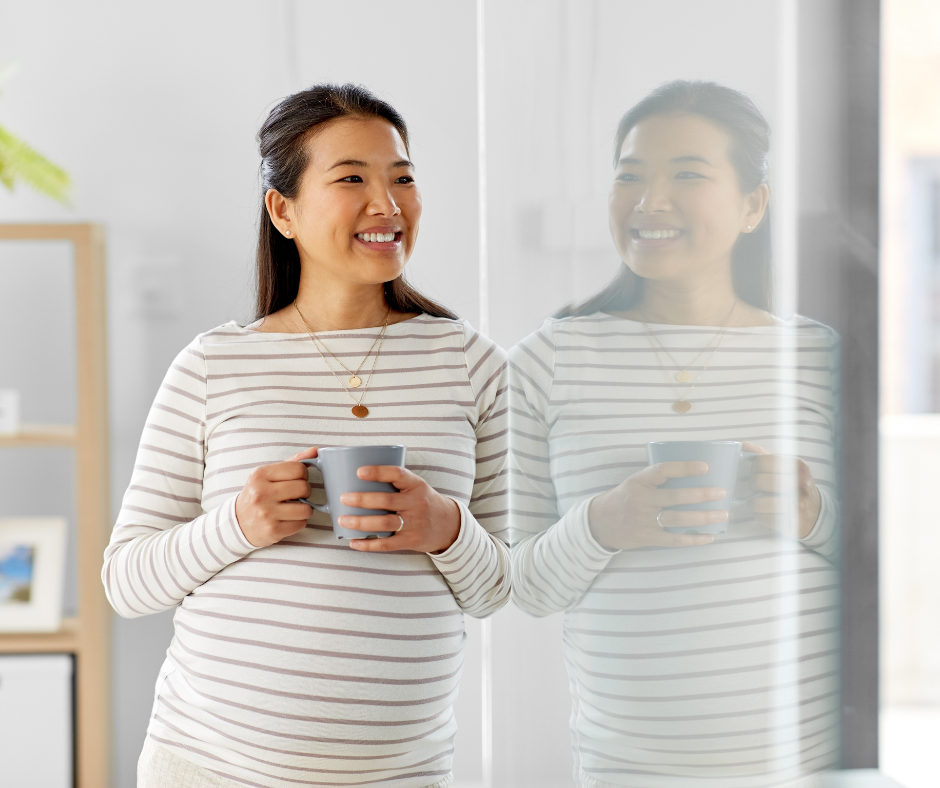 Pregnant woman holding mug